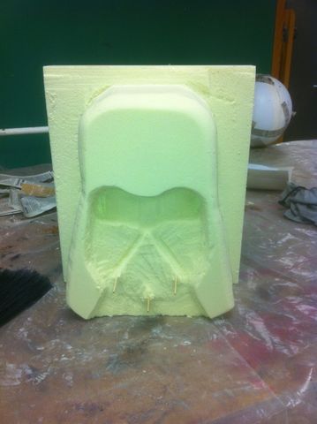 Process shot of a foam carving project. It is the beginnings of a Darth Vader grotesque.