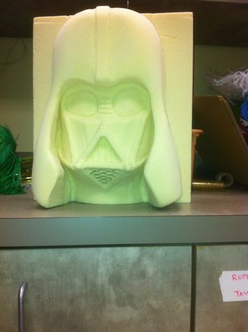 Process shot of a foam carving project. It is a Darth Vader grotesque.