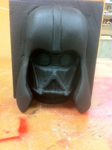 Process shot of a foam carving project. It is a Darth Vader grotesque painted black.